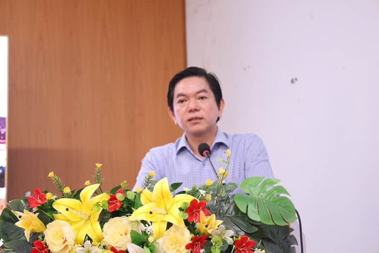 '''A person standing at a podium with flowers
AI-generated content may be incorrect.'''