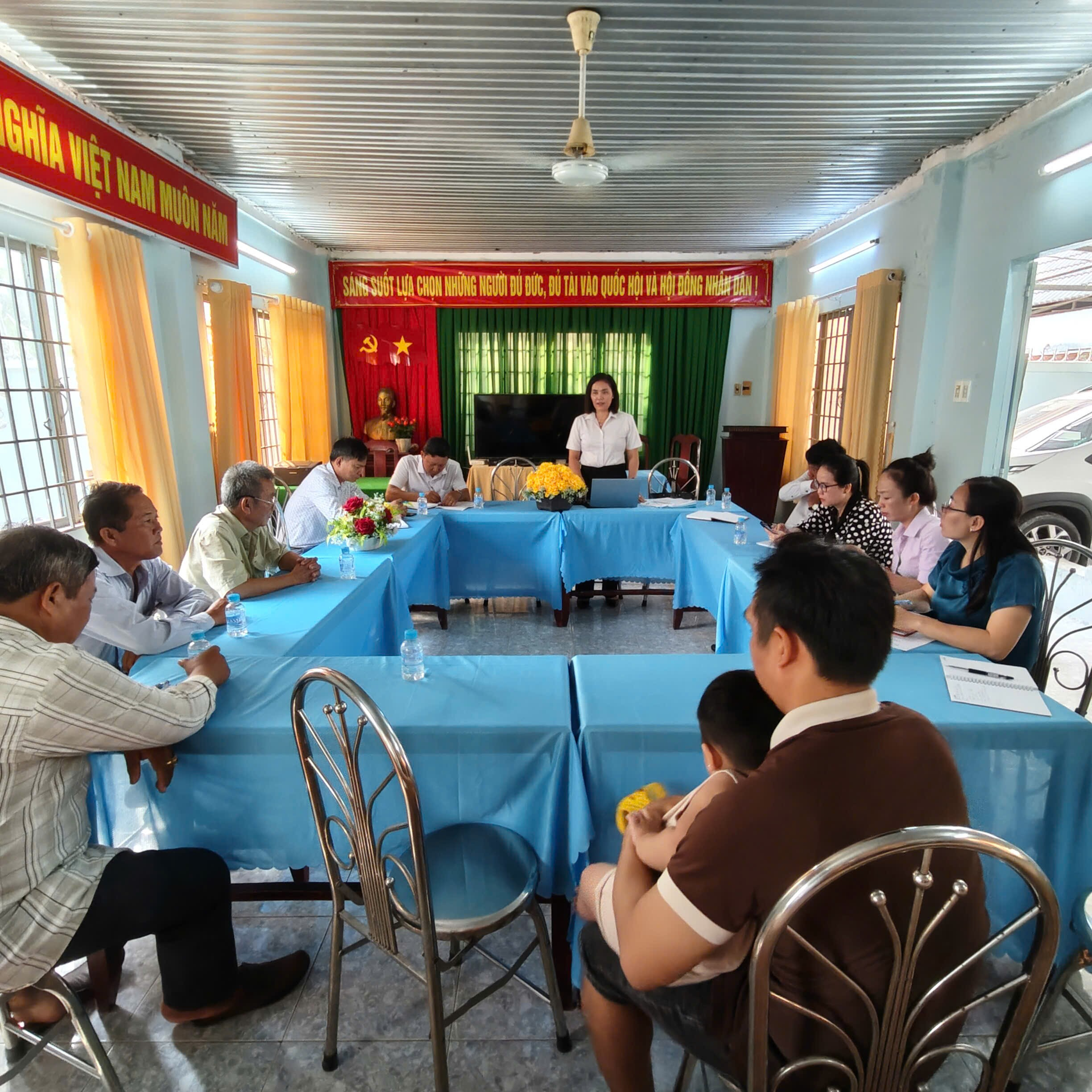 'A group of people sitting around a table
Description automatically generated'