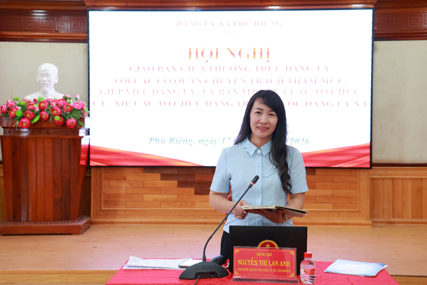 '''A person standing in front of a podium
Description automatically generated'''