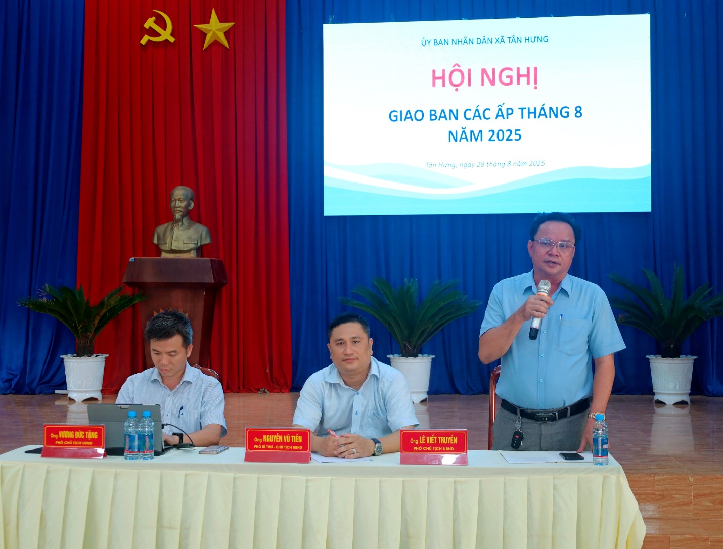 'A group of men sitting at a table
Description automatically generated'