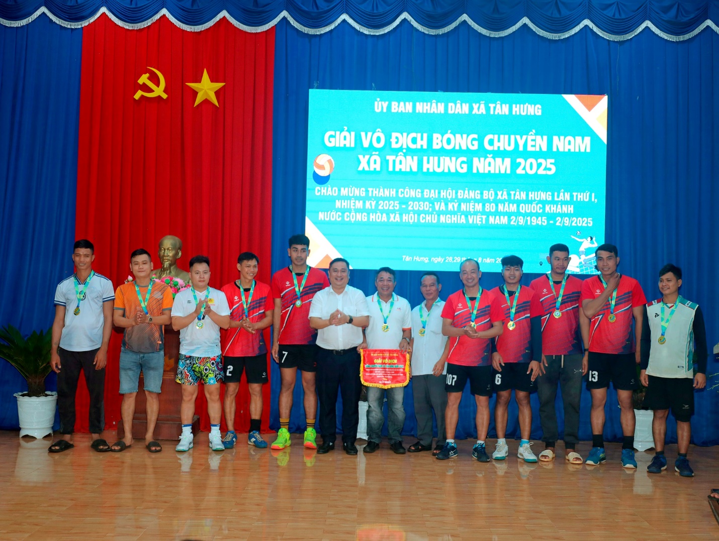 'A group of people standing in front of a screen
Description automatically generated'