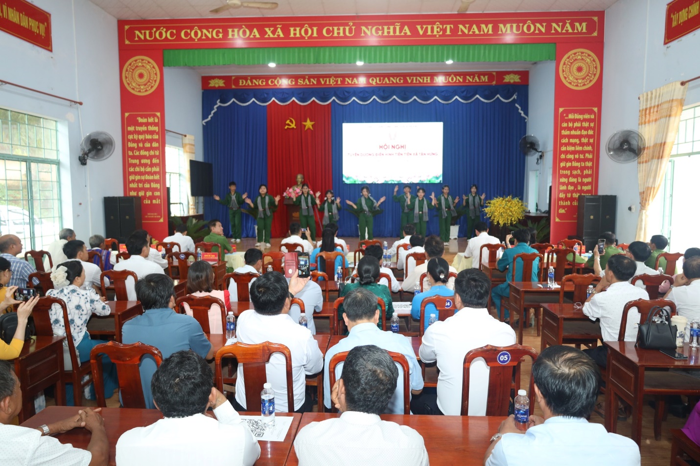 'A group of people in a room
Description automatically generated'