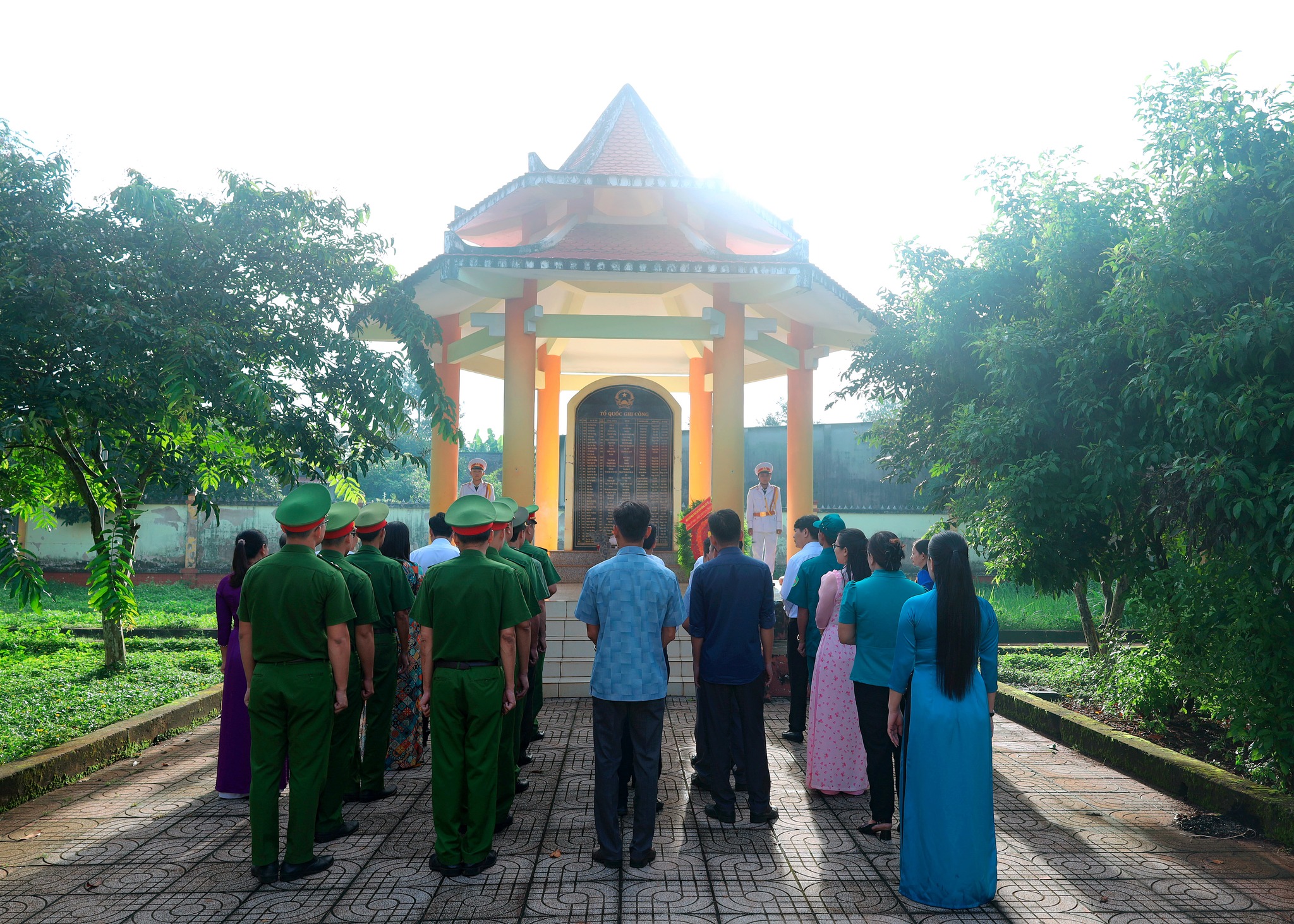 ''A group of people standing in a line outside a building
Description automatically generated''