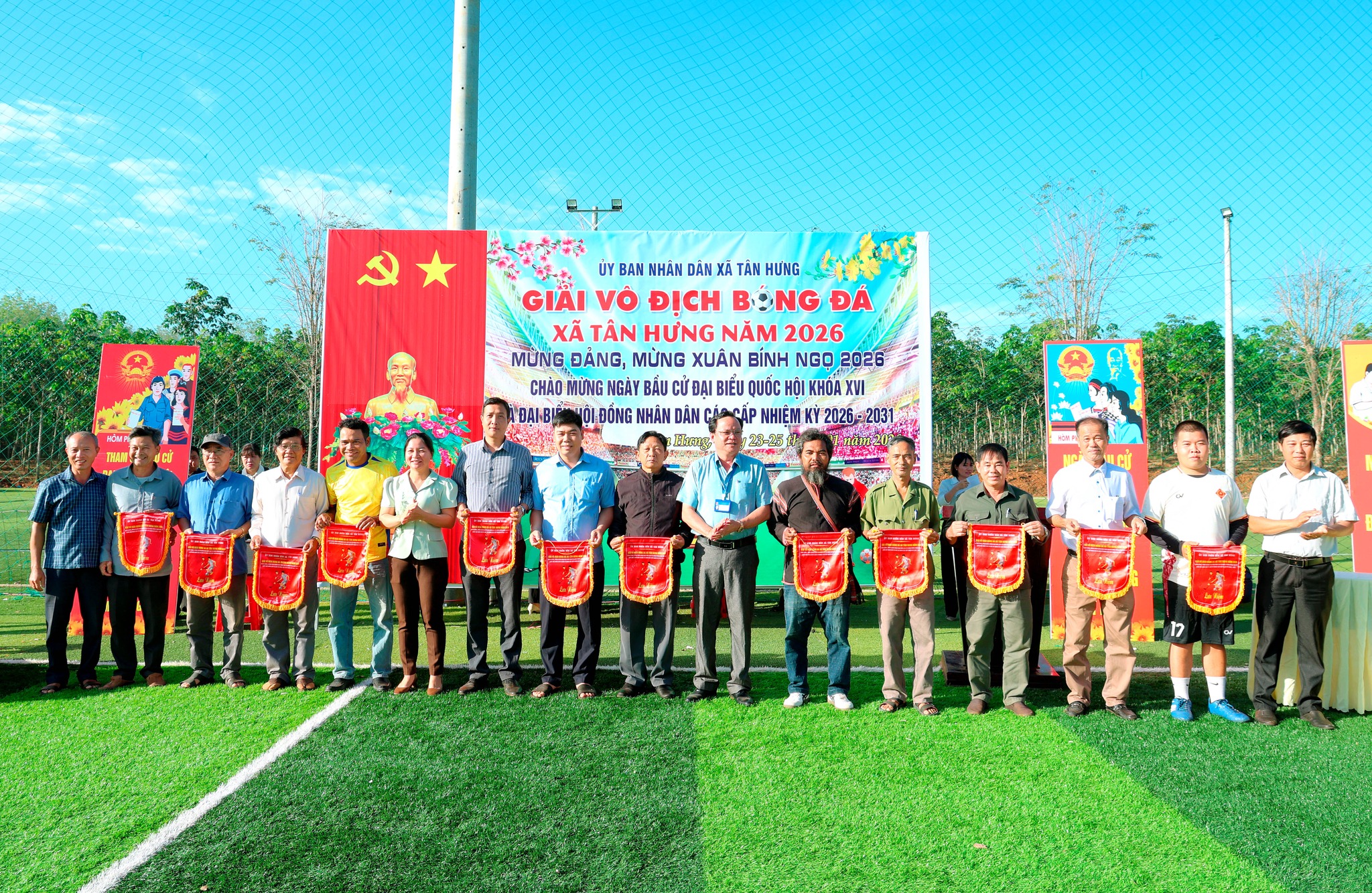 '''A group of people holding flags
Description automatically generated'''