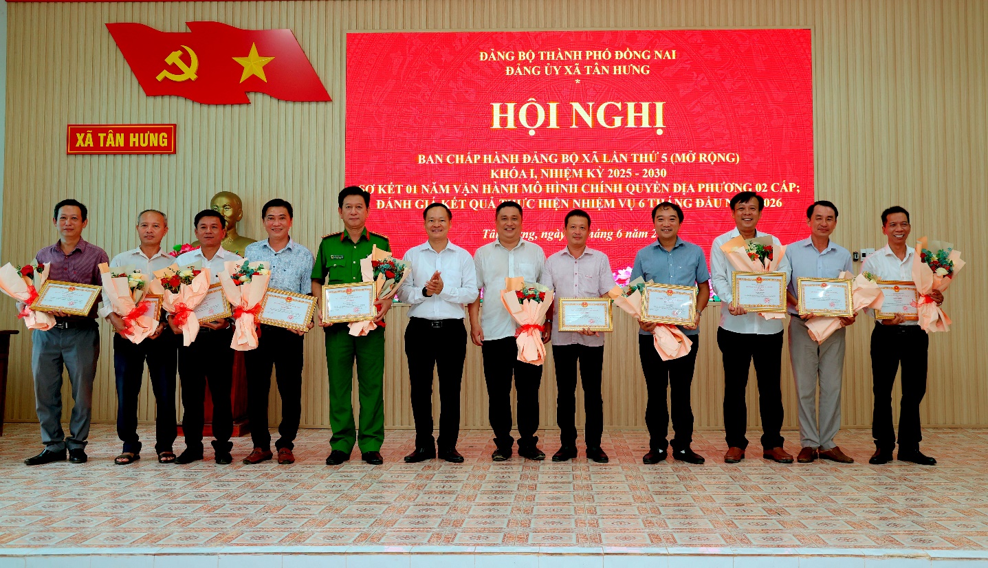 'A group of men holding certificates
Description automatically generated'