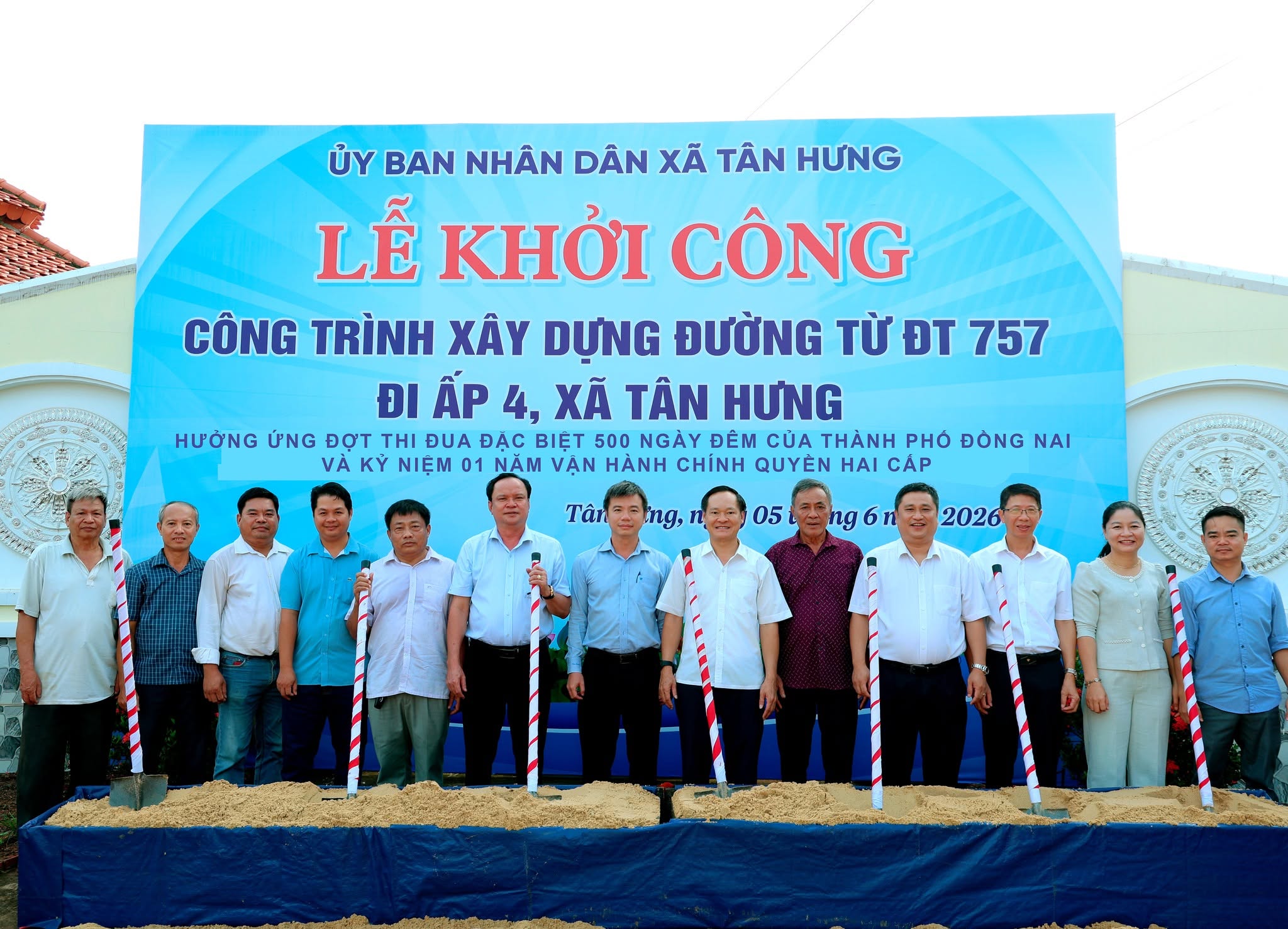 'A group of people standing in front of a banner
Description automatically generated'