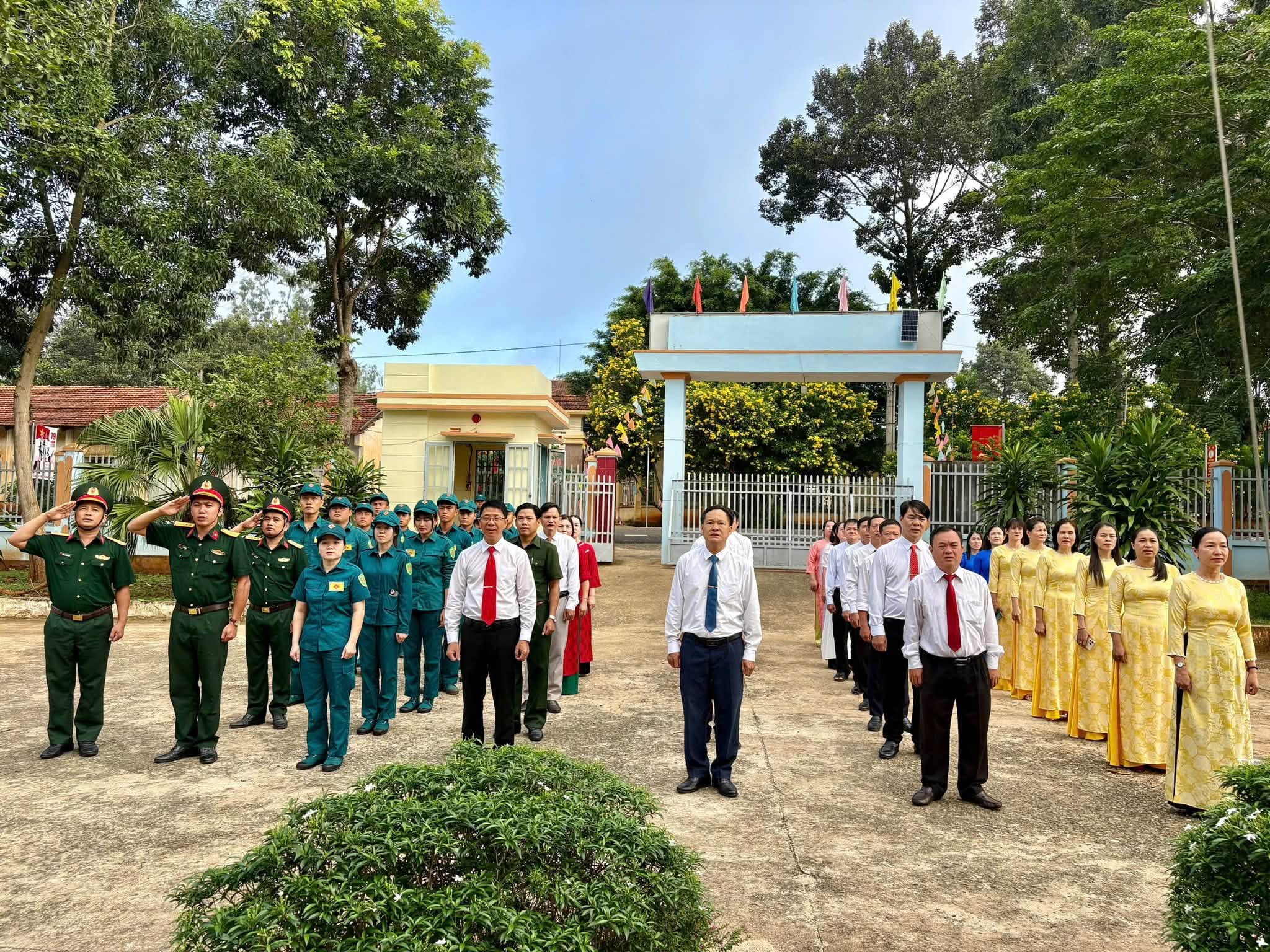 'A group of people standing in front of a gate
Description automatically generated'