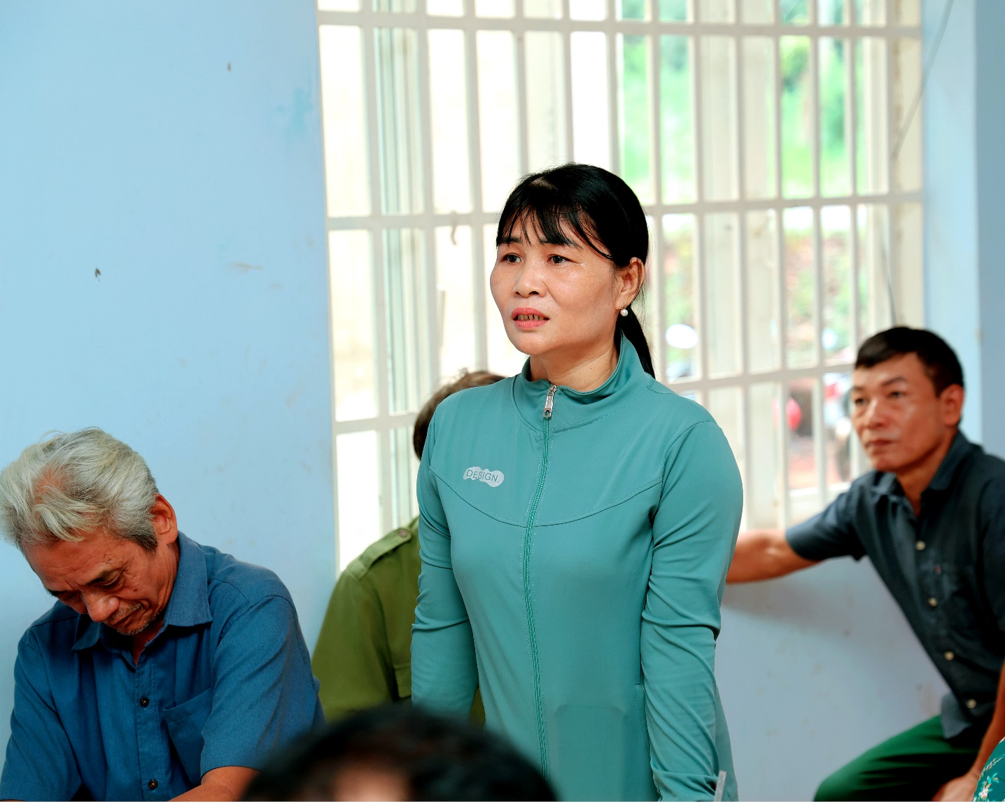 A person standing in front of a group of people
Description automatically generated
