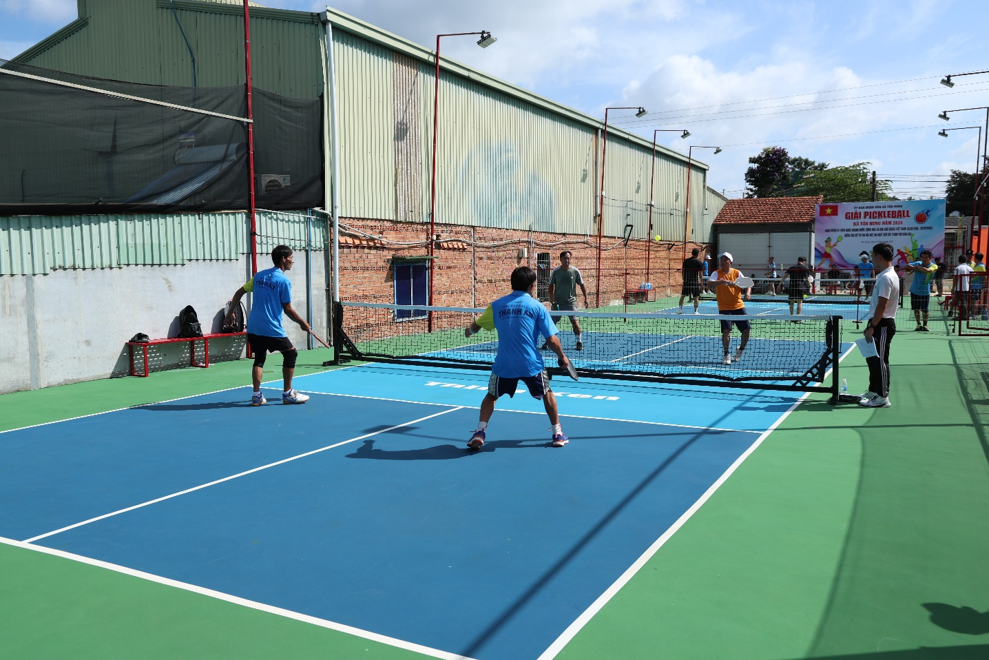A group of people playing tennis
Description automatically generated