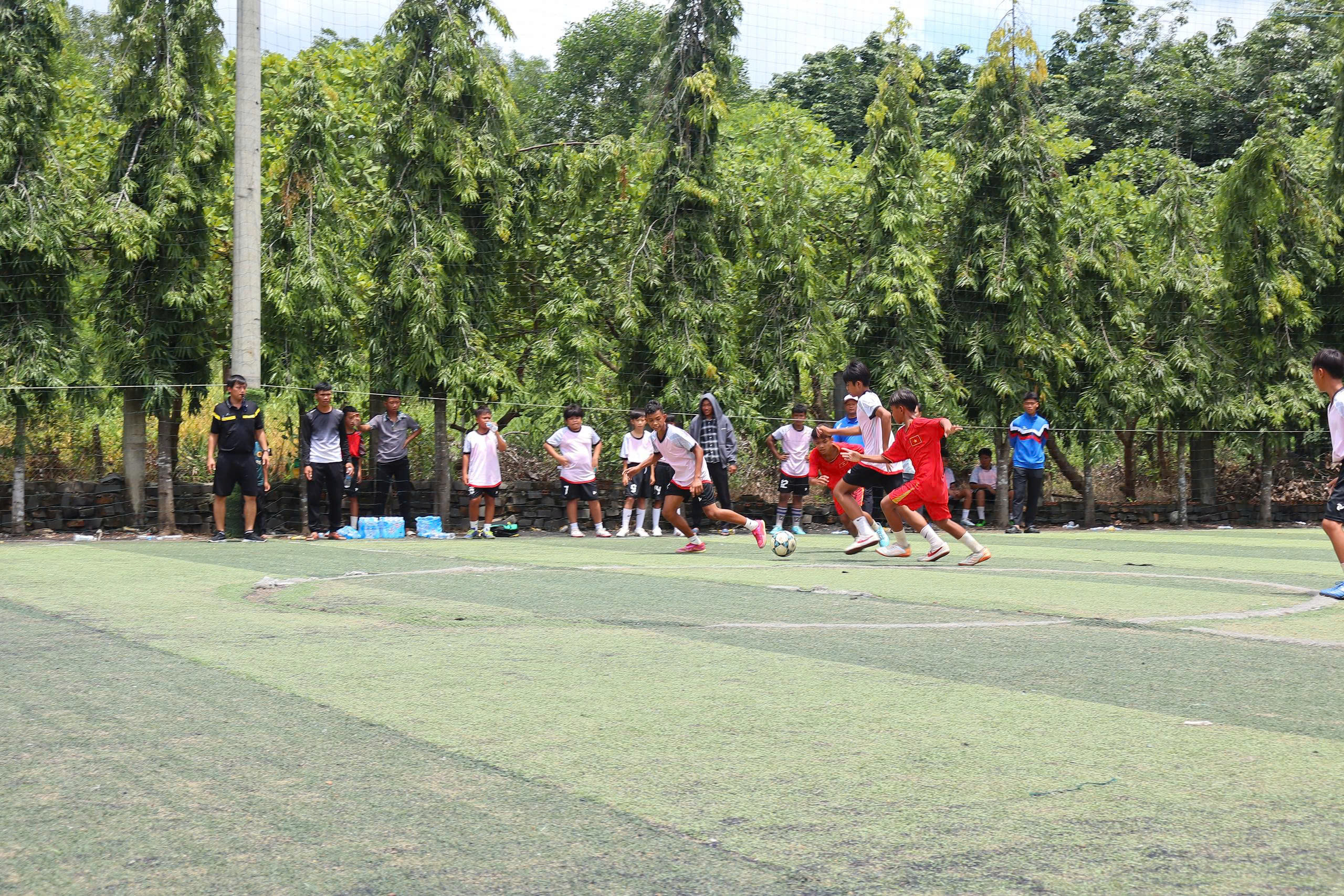 A group of people playing football
Description automatically generated