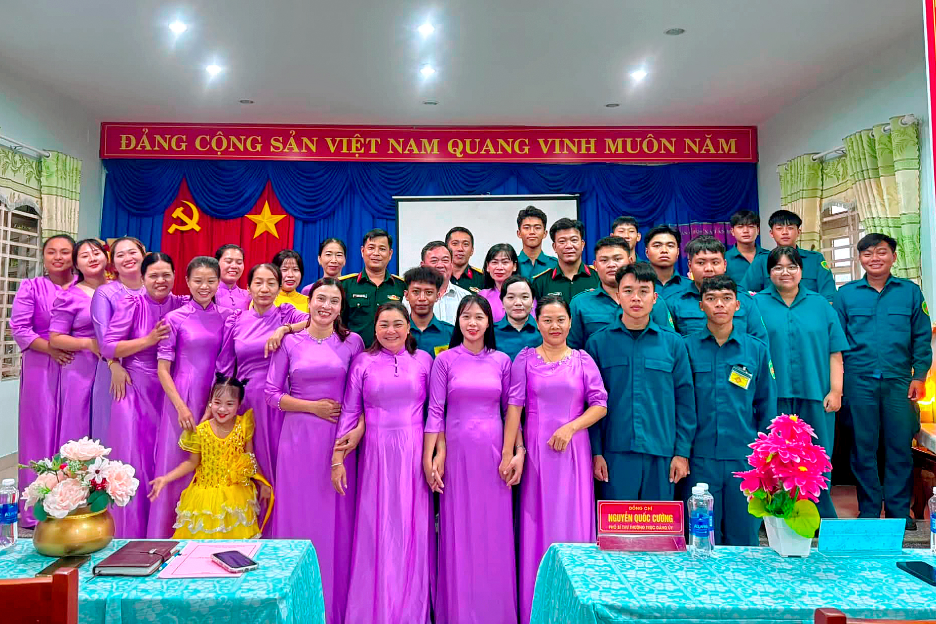 A group of people posing for a photo
Description automatically generated