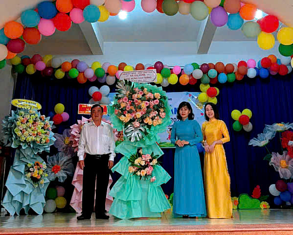 A group of people standing on a stage
Description automatically generated