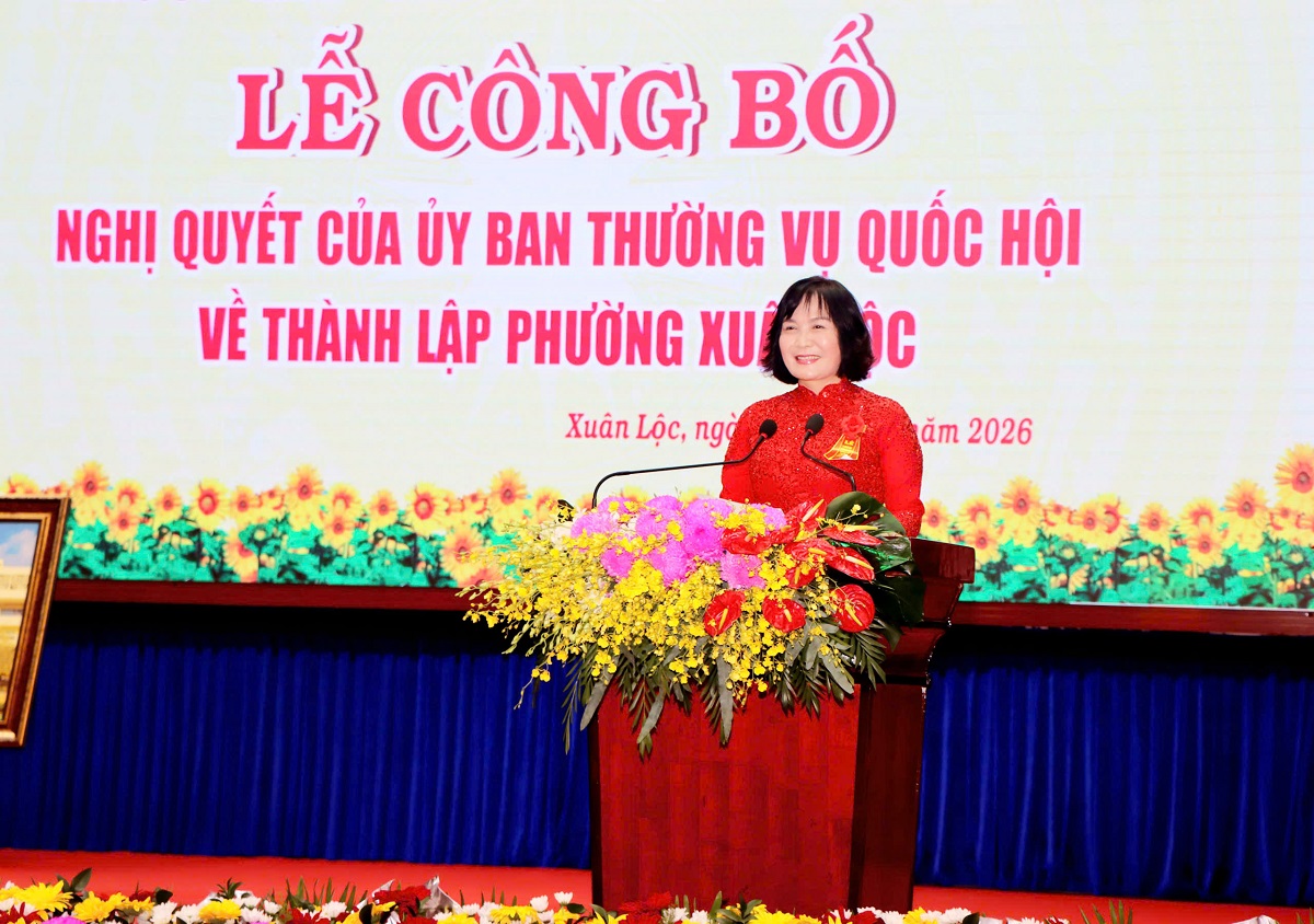 'A person standing at a podium with flowers
AI-generated content may be incorrect.'