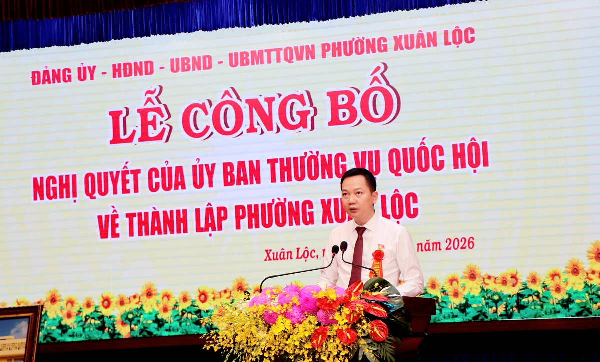 'A person standing at a podium with a microphone and flowers
AI-generated content may be incorrect.'