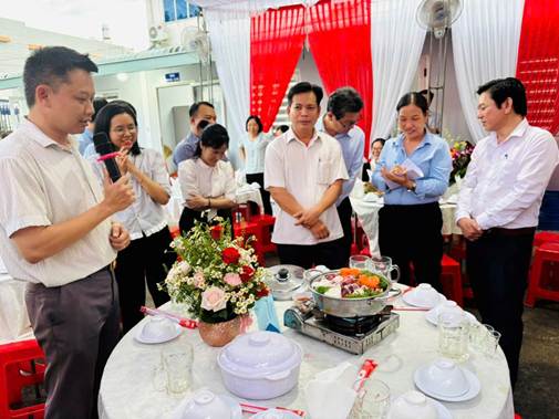 ''A group of people around a table

AI-generated content may be incorrect.''