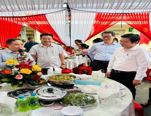 ''A group of people standing around a table with food

AI-generated content may be incorrect.''