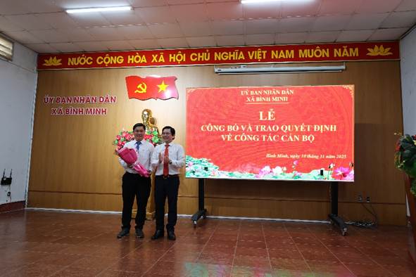 '''''Two men standing in front of a large screenAI-generated content may be incorrect.'''''