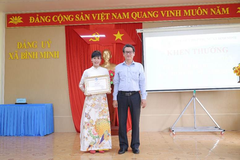 '''''A person and person standing in front of a stage

AI-generated content may be incorrect.'''''