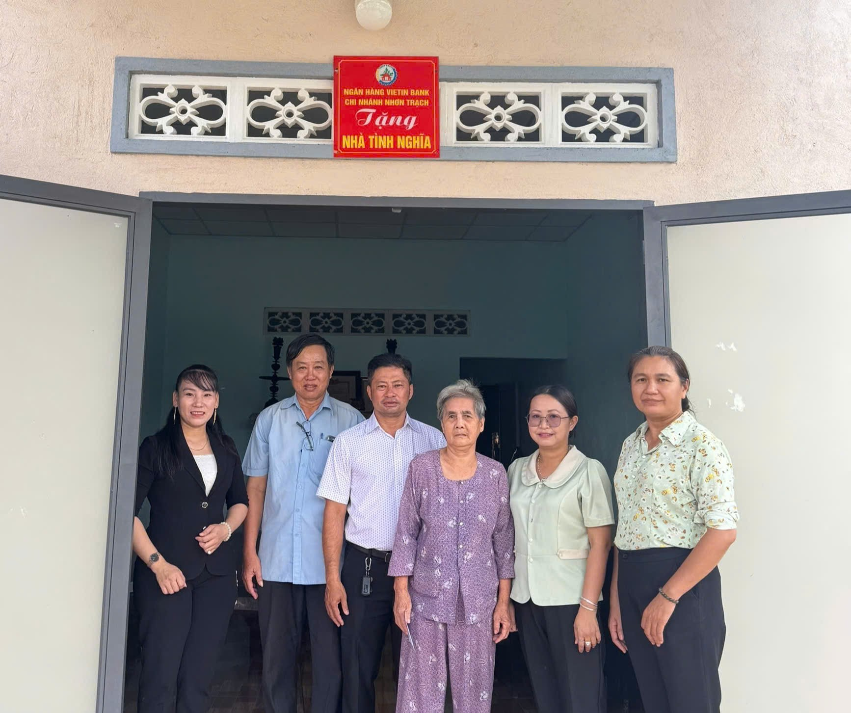 ''A group of people standing in a doorway

Description automatically generated''