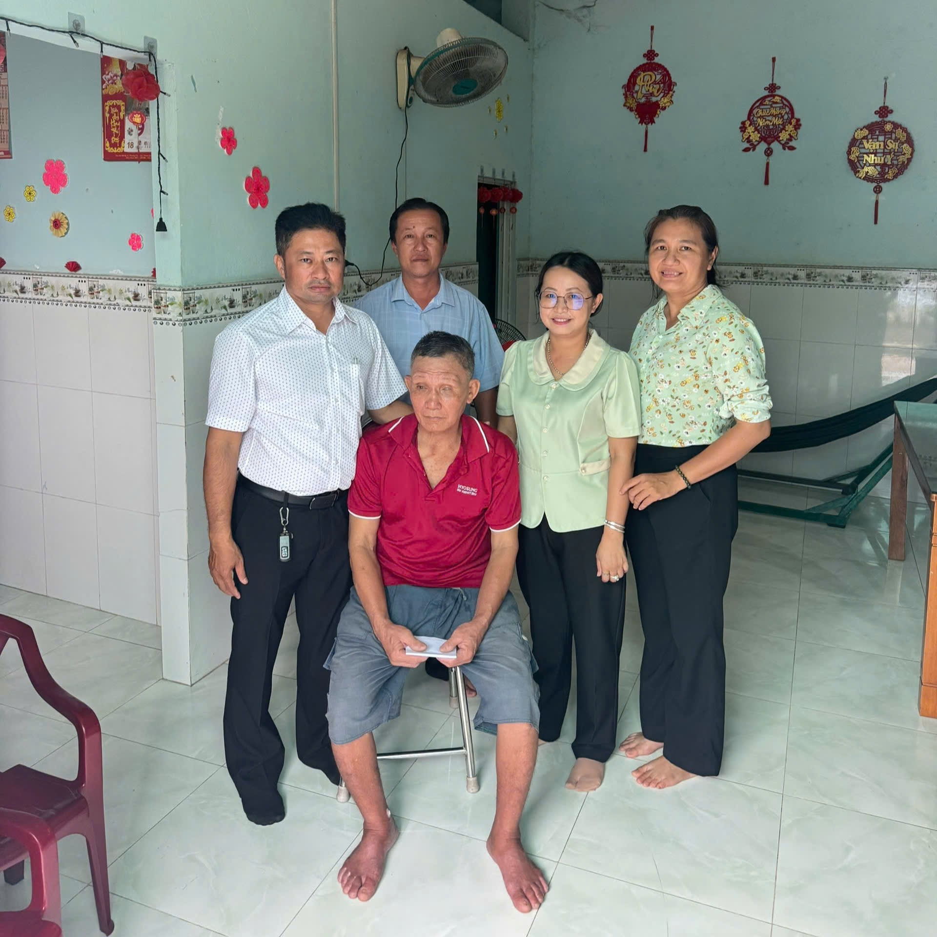 ''A group of people posing for a photo

Description automatically generated''