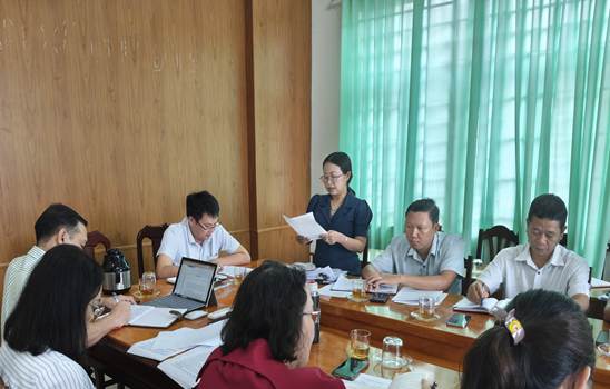 ''A group of people sitting around a table

Description automatically generated''