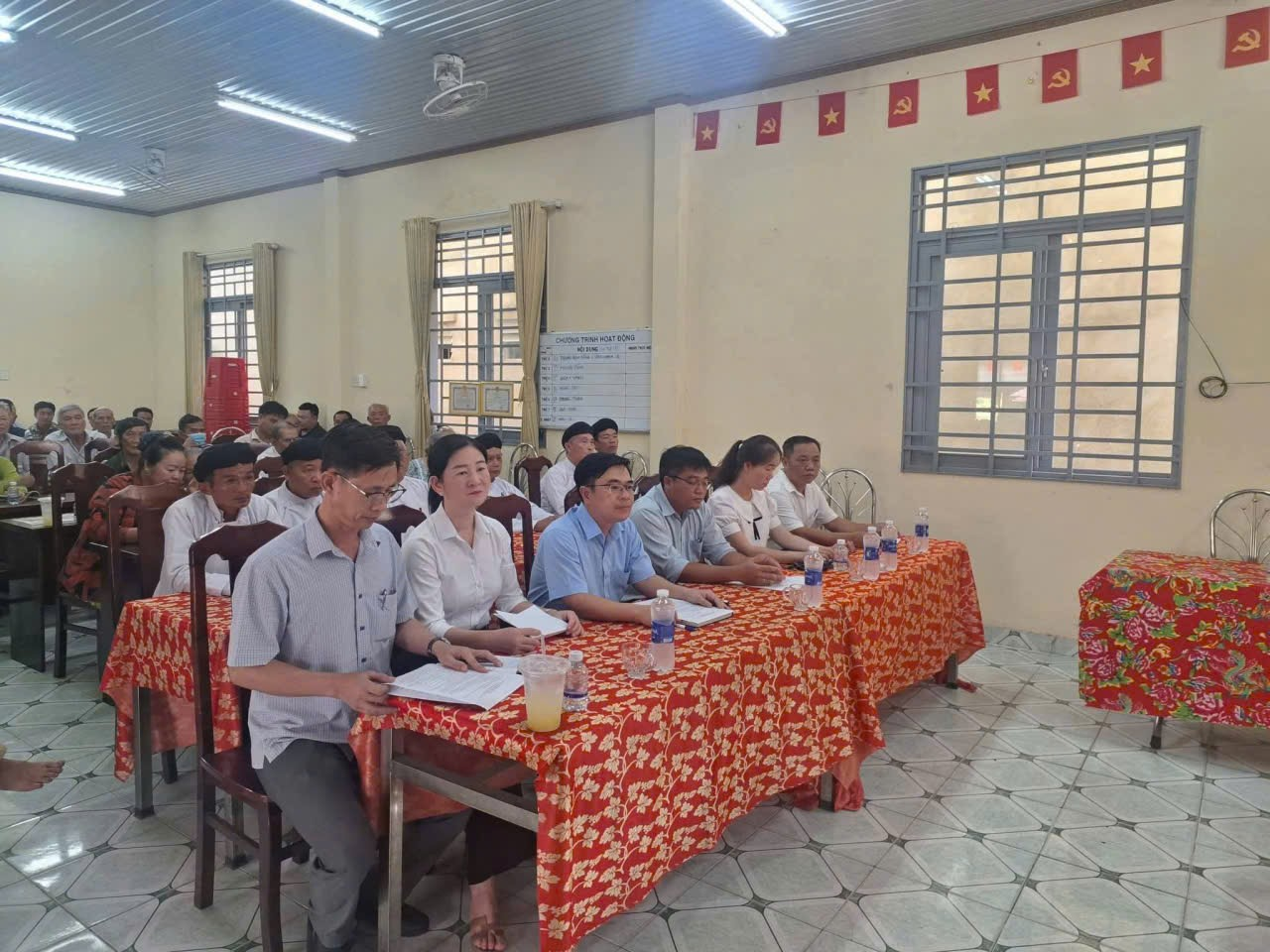 'A group of people sitting at a table

Description automatically generated'