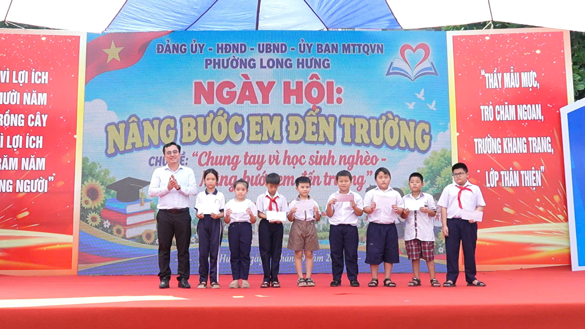Đ/c Kiều Minh Sinh - Phó Bí thư Thường trực Đảng uỷ phường Long Hưng trao học bổng cho các em học sinh có hoàn cảnh khó khăn tại ngày hội "Nâng bước em đến trường" phương Long Hưng năm 2026.