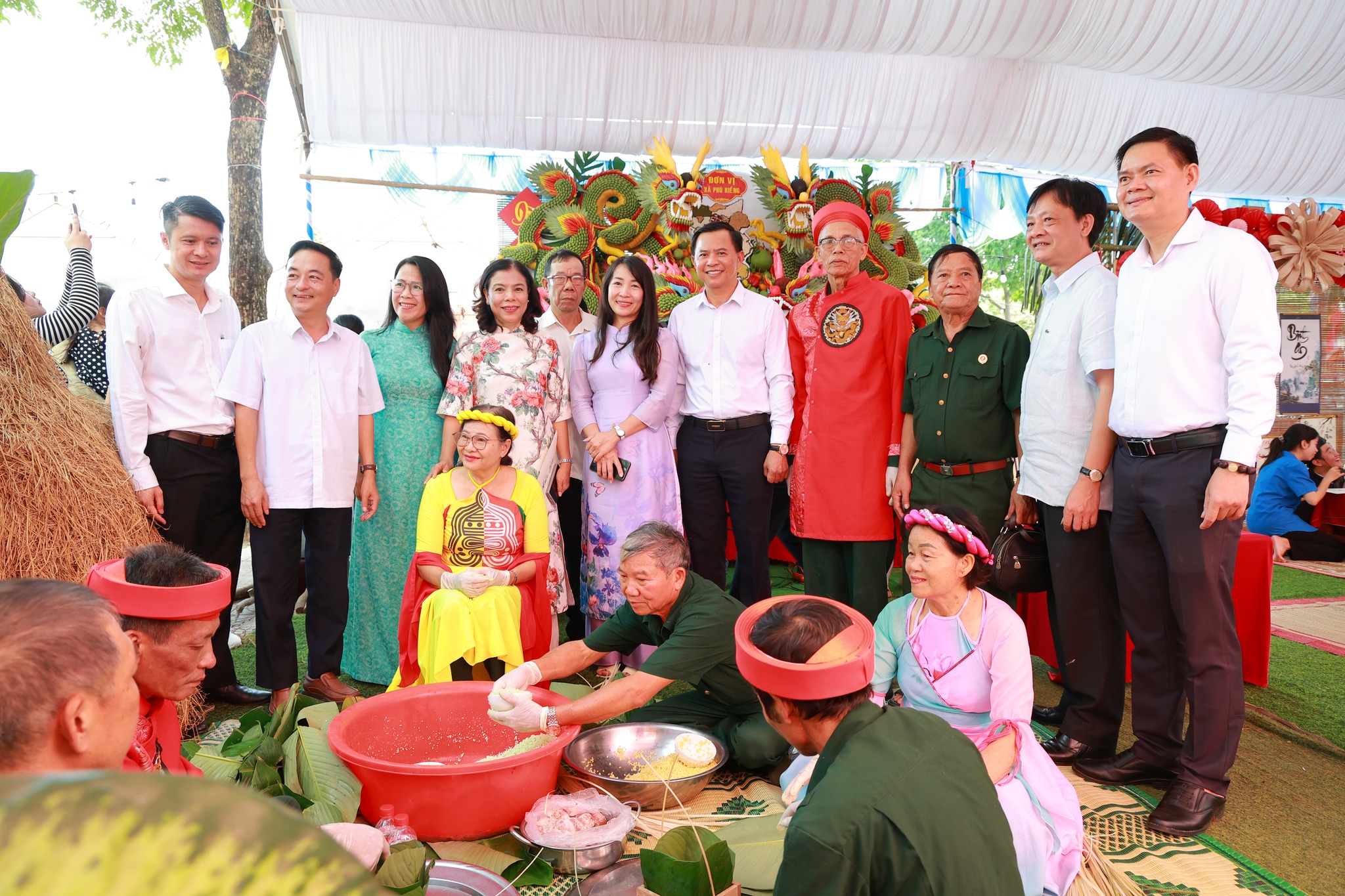 'A group of people standing under a tent

Description automatically generated'