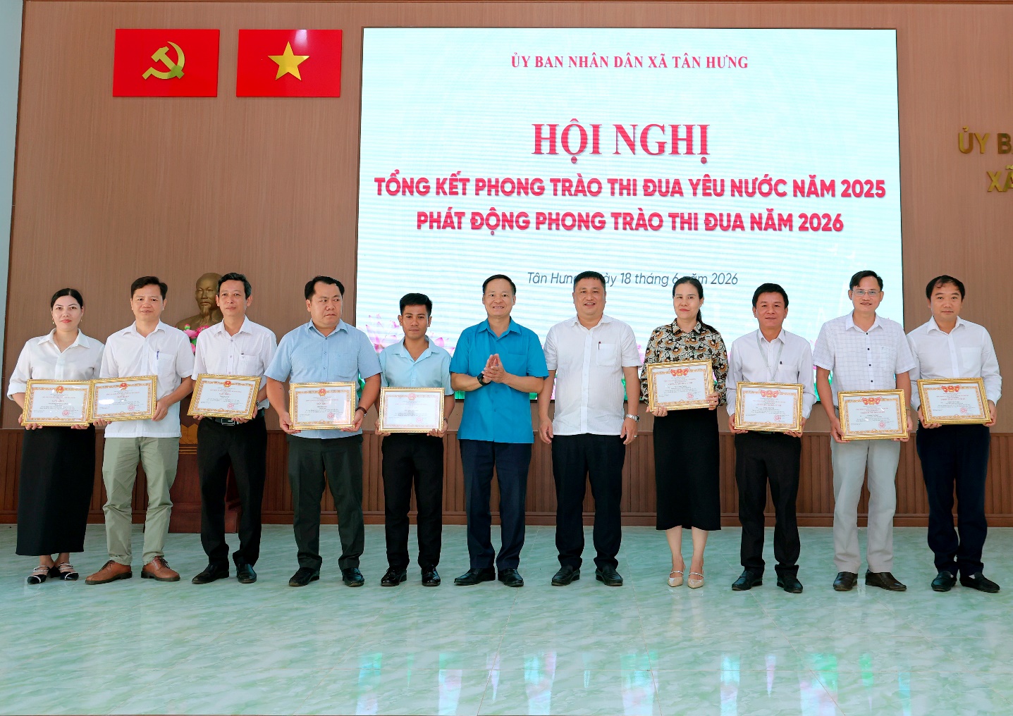 'A group of people holding certificates

Description automatically generated'