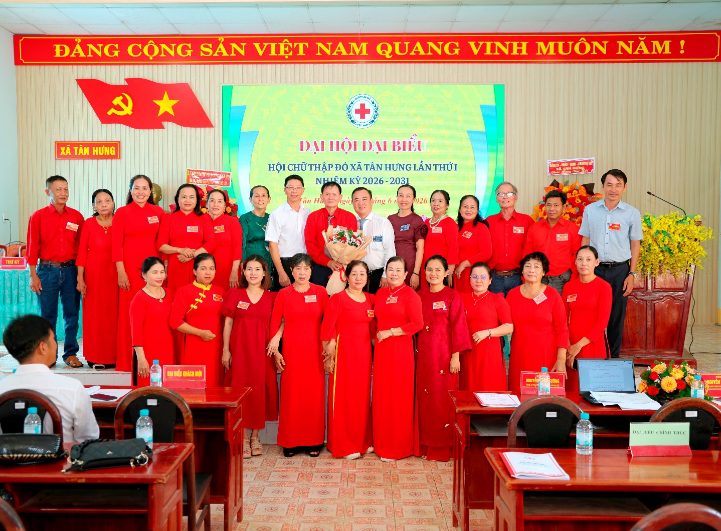 ''A group of people in red dresses

Description automatically generated''