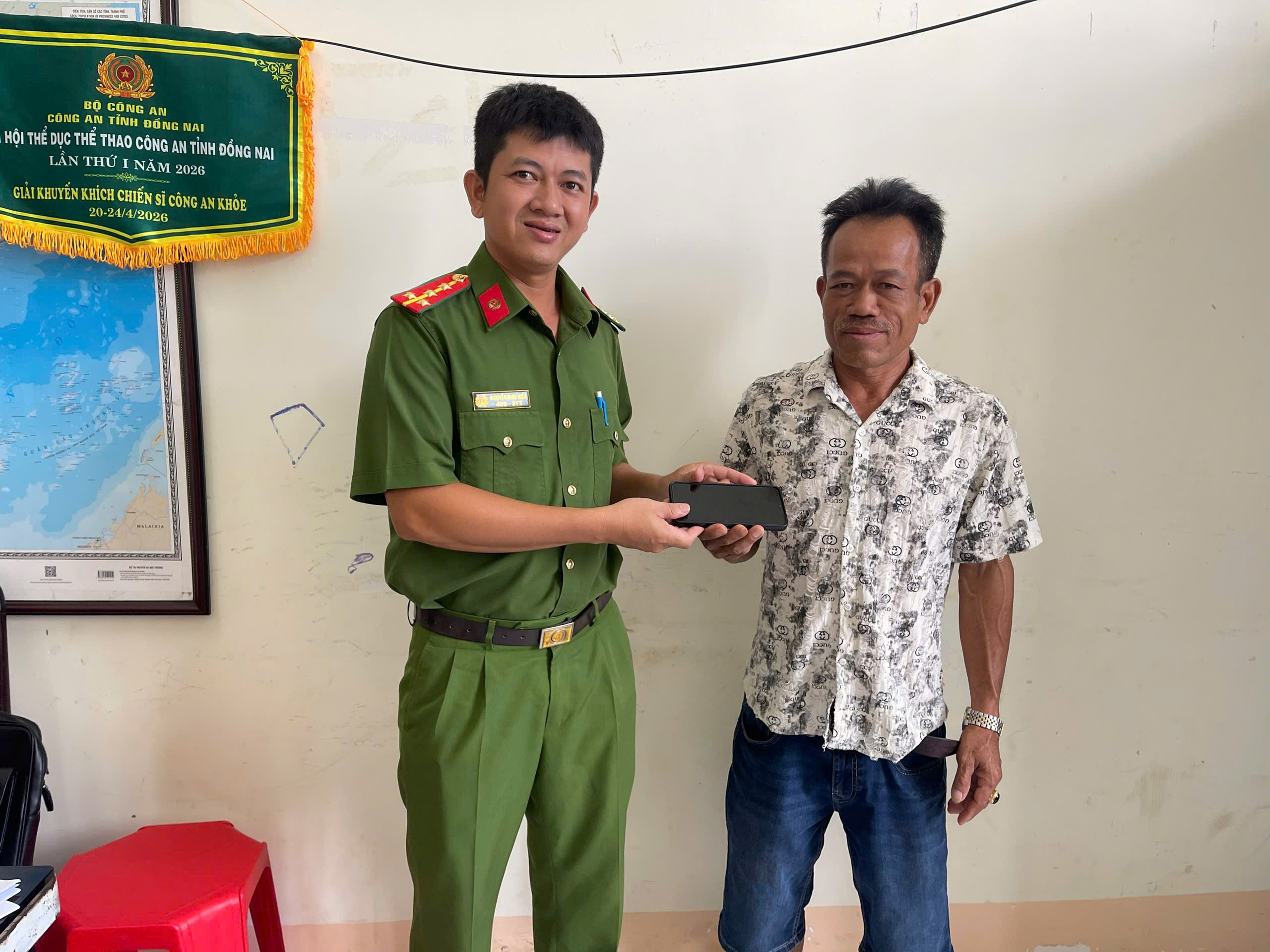 Anh P.V.D bàn giao điện thoại cho lực lượng Công an xã để tìm và trả lại người đánh rơi