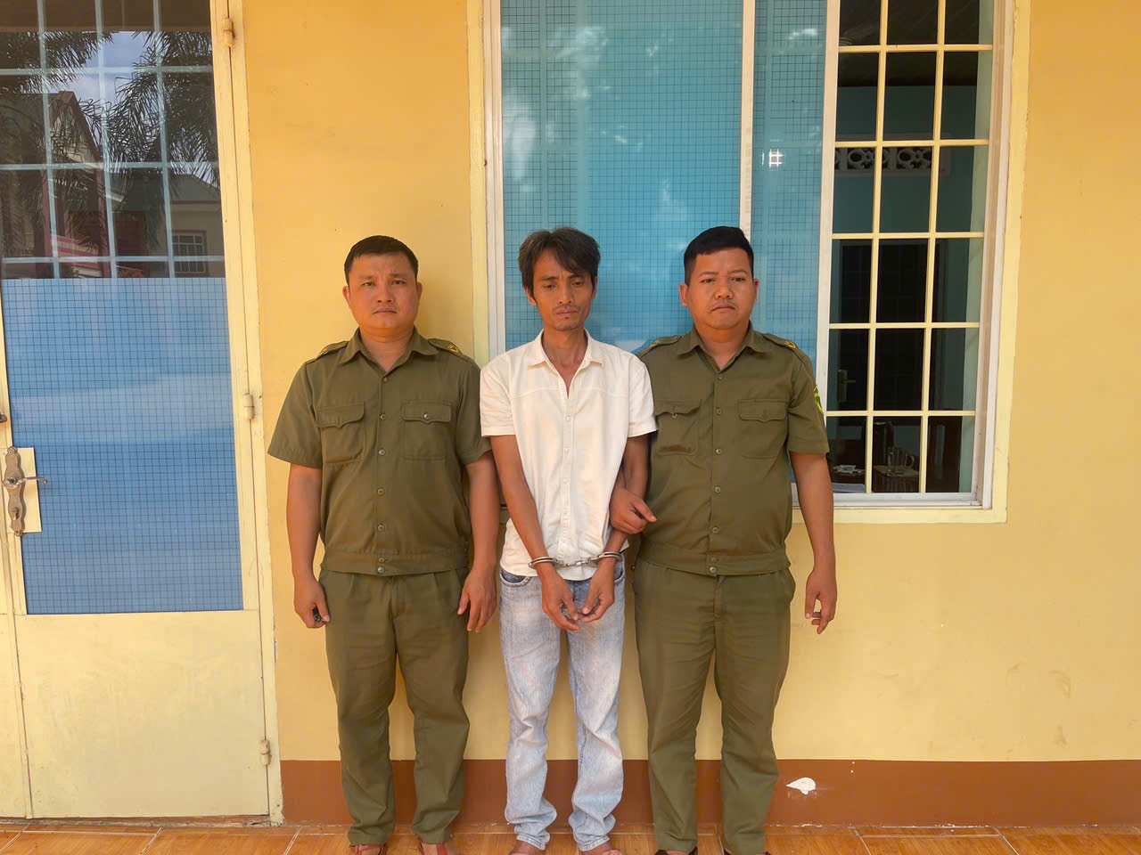 ''Description: A group of men standing in front of a yellow wall

AI-generated content may be incorrect.''